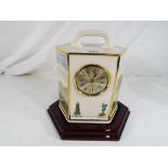 A good quality ceramic mantel clock with a golfing theme by Pointers of London and Edinburgh,