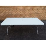 A folding buffet-banquet table approximately 71 cm x 178 cm x 76 cm.