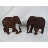 Two carved wooden models depicting elephants approx 15.
