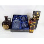 A premium glass whisky decanter with two matching glasses in presentation box,