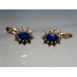 A pair of lady's 14 carat gold sapphire and diamond cluster earrings stamped 585.