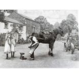 John S Gibb - a black and white print depicting a farrier signed in pencil to the margin mounted