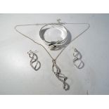 A good quality white metal torque / bangle bracelet in the form of a buckle and a set of matching