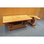 A wooden coffee table raised on carved elephant supports,