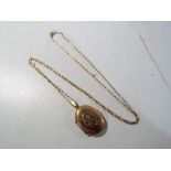 A lady's 9 ct gold necklace and 9 ct gold locket stamped 375, boxed, approximate weight 3.