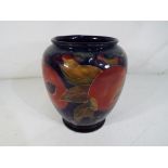 Moorcroft Pottery - a Moorcroft Pottery vase decorated with pomegranate signed to the base and