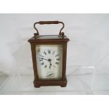 A French 8-day carriage clock, brass case with bevelled glasses, time and alarm feature,