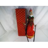 An Oriental style wooden carved puppet in Chinese theatrical dress, original box,