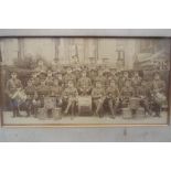 A photograph mounted and framed under glass depicting a World War One period military band.