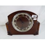 An oak cased mantle clock Arabic numerals chapter ring,