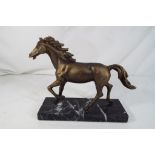 A cast bronzed statue depicting a horse on a marble plinth height including plinth 18.5cms x 23.