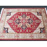A Keshan carpet on a red ground measuring 200cm x 280cm Est £80 - £120