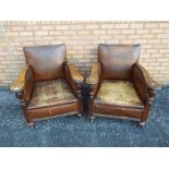 Two leather upholstered armchairs with wooden arms, sat on castors [2].
