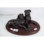 A bronzed study depicting two dogs on wooden plinth cast signature Doris Lindner approx 14cm (h)