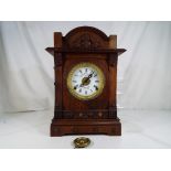 An oak cased table alarm clock by Fattorini and Sons, Bradford,