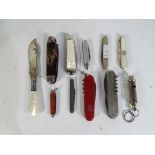 A collection of pocket and penknives to include a silver and mother of pearl handled example