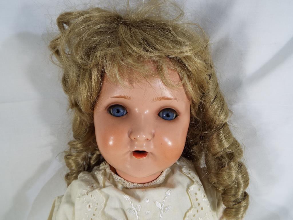 A bisque headed dressed doll with glass sleeping eyes, open hand painted mouth, with jointed limbs, - Image 2 of 5