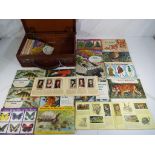 A small vintage suitcase containing a quantity of cigarette card and tea card books containing