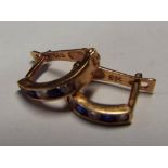 A pair of 14 carat gold diamond and sapphire clip earrings, stamped 585.