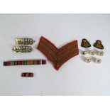 A collection of military items to include rank badge,