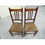 Two dinning chairs with woven seats.