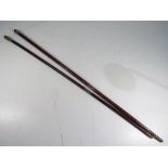 Two swagger sticks one with a hallmarked silver top,