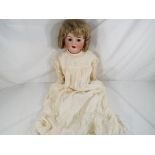 Kammer & Reinhardt - a bisque headed dressed doll by Kammer & Reinhardt with sleeping glass eyes,