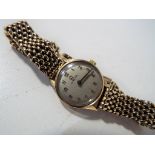 A lady's 9 carat gold cased Omega wristwatch with 9 carat gold bracelet,