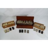 Three wood cased sets of vintage dominoes comprising a bone and ebony double nine set with spinners