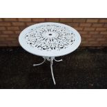 A white painted wrought iron circular garden table,