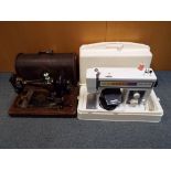 A decorative vintage Singer sewing machine in wood case and a Toyota Sewing machine (2)