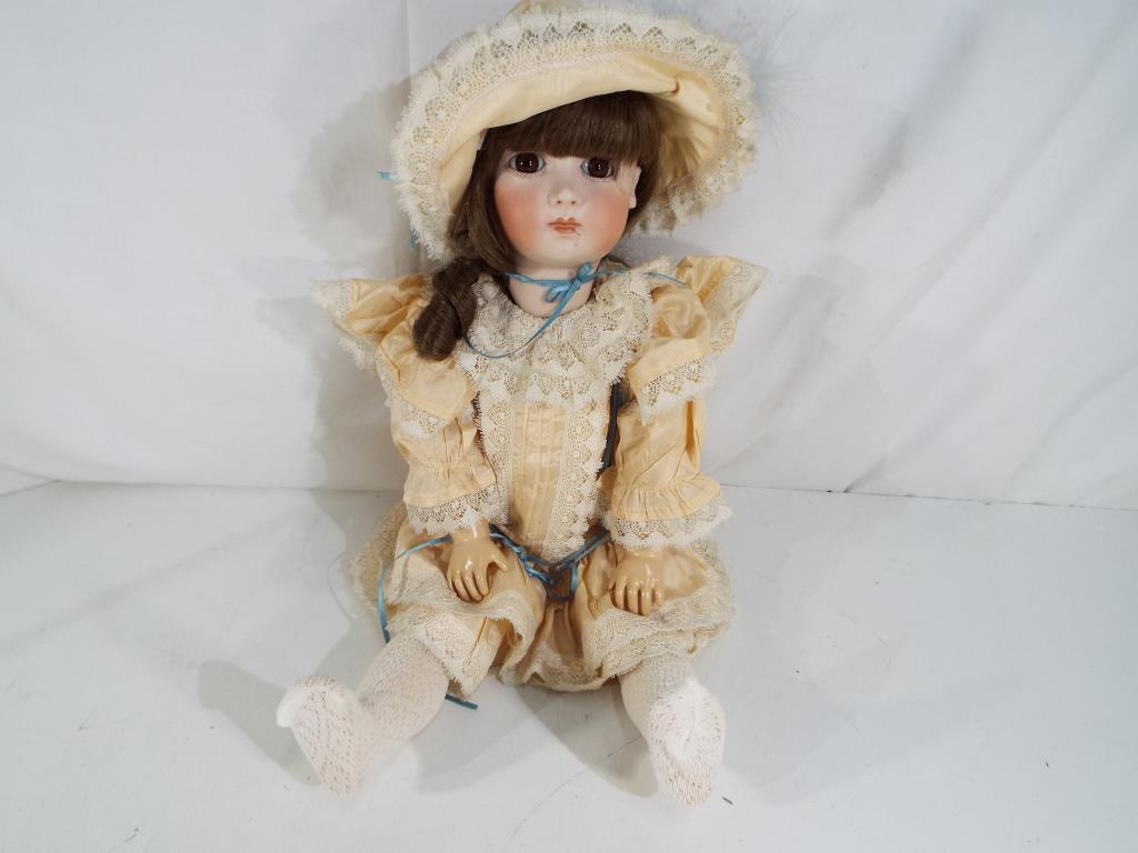 Cabinet Doll - a bisque headed cabinet size dressed doll with glass eyes,