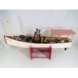 A scratch built steam powered pond yacht named African Queen on wooden stand approx 26cm x 73cm x