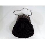 A lady's Victorian black velvet evening bag with white metal mounts, clasp and chain,
