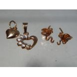 A pair of 14 carat gold earrings in the form of snakes and two 14 carat gold pendants,
