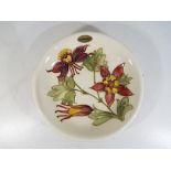 Moorcroft Pottery - a large Moorcroft Pottery shallow bowl decorated with columbine on a cream