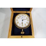 A white metal travel / car clock with a white dial, Swiss made with Arabic numerals and second dial,