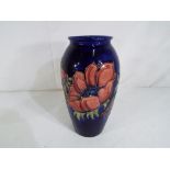 Moorcroft Pottery - a large Moorcroft Pottery vase decorated with anemone on a blue ground signed