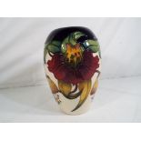 Moorcroft Pottery - a Moorcroft Pottery vase decorated in the Anna Lily pattern approx 18cm (h) Est