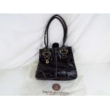 Dents - a Dents black leather handbag with key ring logo and protective cloth bag