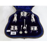 A George V silver hallmarked cased five piece condiment set,