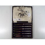 A cased set of George V silver handled butter knives,