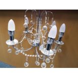 A modern good quality chrome five arm chandelier with glass detailing Est £20 - £40
