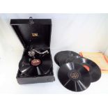 An HMV portable gramophone with a small quantity of records.
