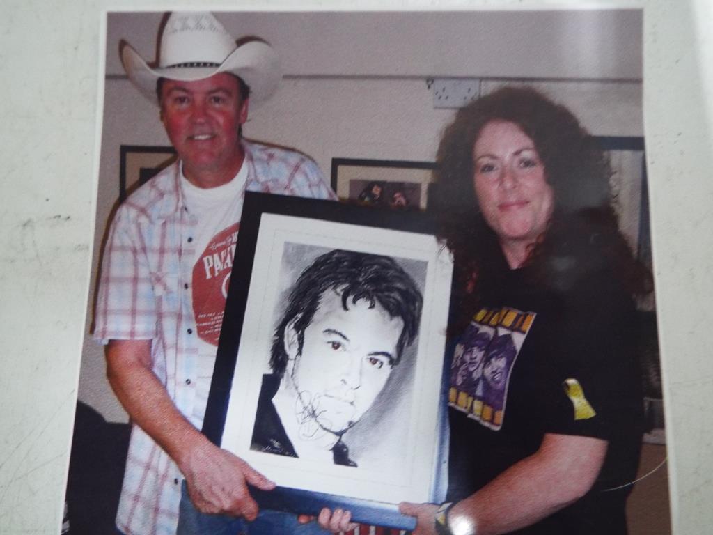 A charcoal on paper drawing of Paul Young by Madelaina Murthwaite mounted and framed under glass,