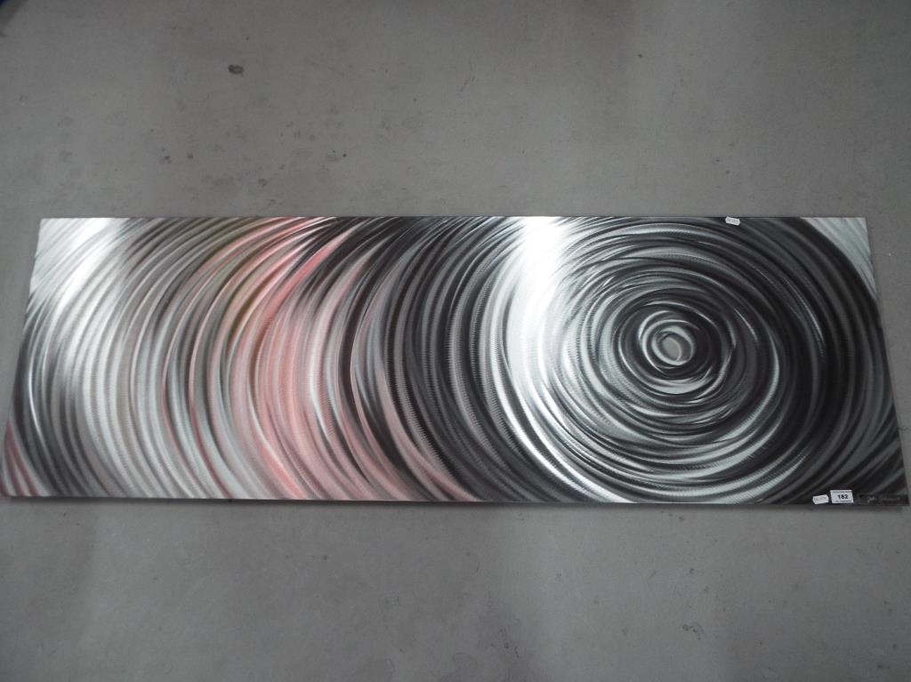 A large piece of contemporary wall art on a silver mirror backing by Jake Johnson with applied