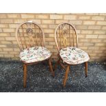 Ercol - a matched pair of Ercol dining chairs with upholstered removable cushions