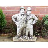 A stoneware garden ornament depicting Laurel and Hardy,