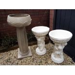 A matched pair of bird baths, the supports in the style of cherubs,