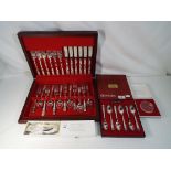 A wood cased canteen of silver plated cutlery by Oneida with a cased set of matching coffee spoons,